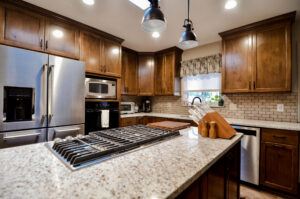 After picture of a remodeled kitchen with walnut wood cabinets