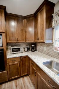 After picture of a remodeled kitchen with walnut wood cabinets