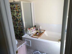 Before picture of a bathroom with a tub