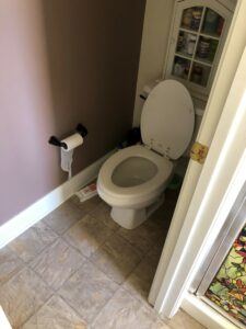 Before picture of a bathroom with a separate room for the toilet