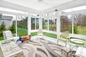 After picture of a sunroom and the green grass view