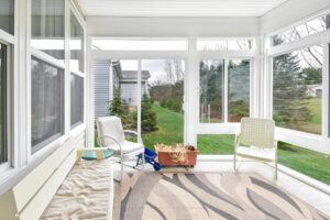 After picture of a sunroom and the green grass view